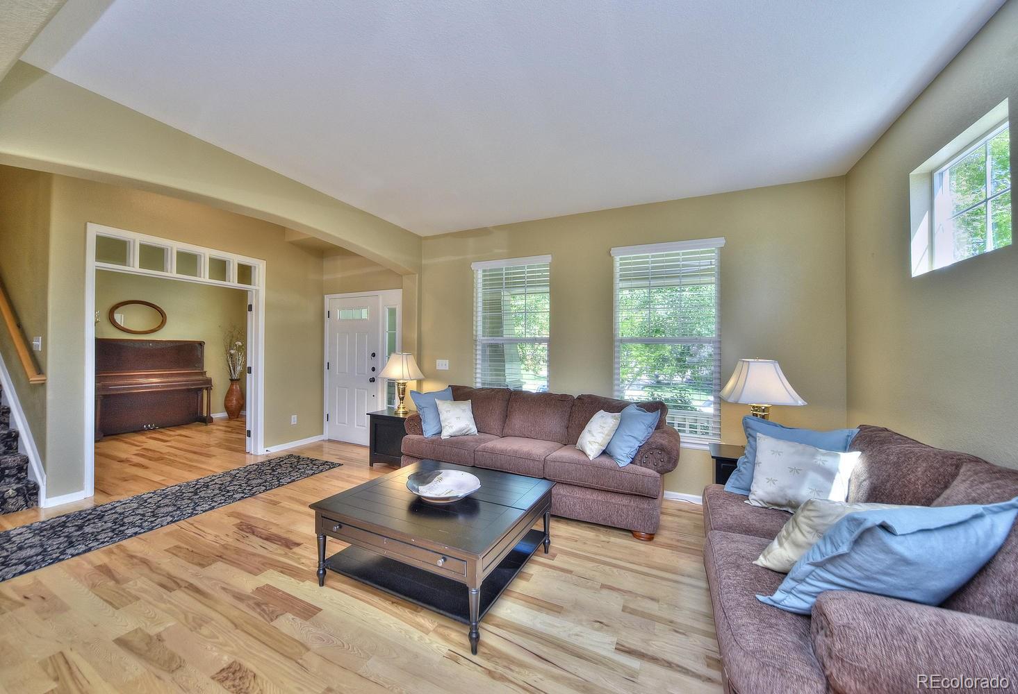4464 Eagle River Run Broomfield, CO 80023 - Photo 4 of 32 a living room with furniture and a wooden floor