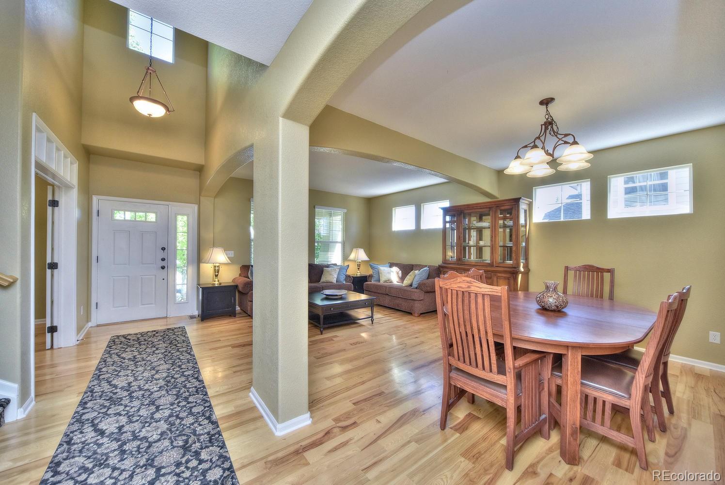 4464 Eagle River Run Broomfield, CO 80023 - Photo 5 of 32 a view of a dining room with furniture and wooden floor