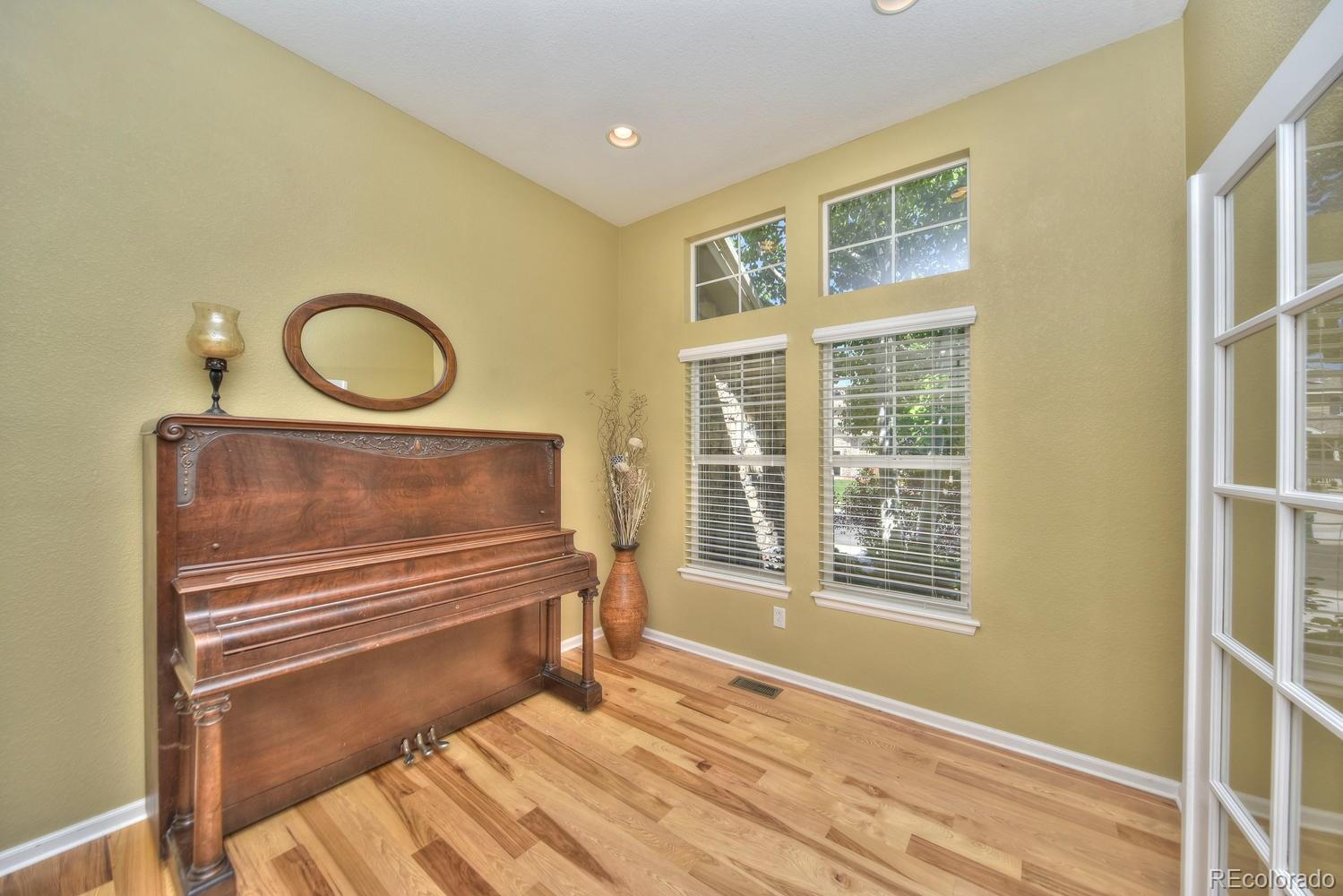 4464 Eagle River Run Broomfield, CO 80023 - Photo 6 of 32 a view of a room with wooden floor and window