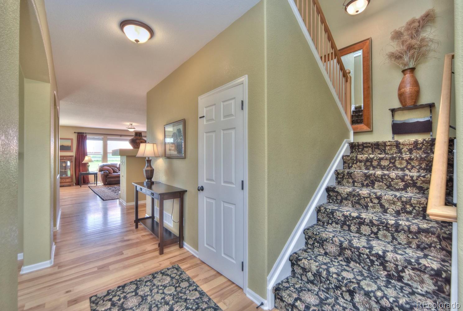 4464 Eagle River Run Broomfield, CO 80023 - Photo 7 of 32 a living room with furniture and a rug