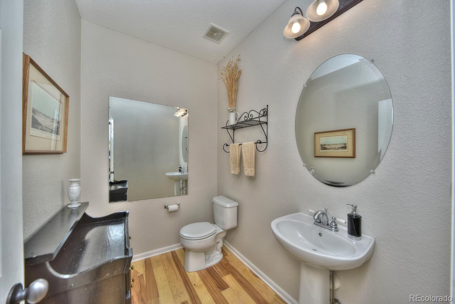 4464 Eagle River Run Broomfield, CO 80023 - Photo 8 of 32 a bathroom with a sink a toilet and a mirror