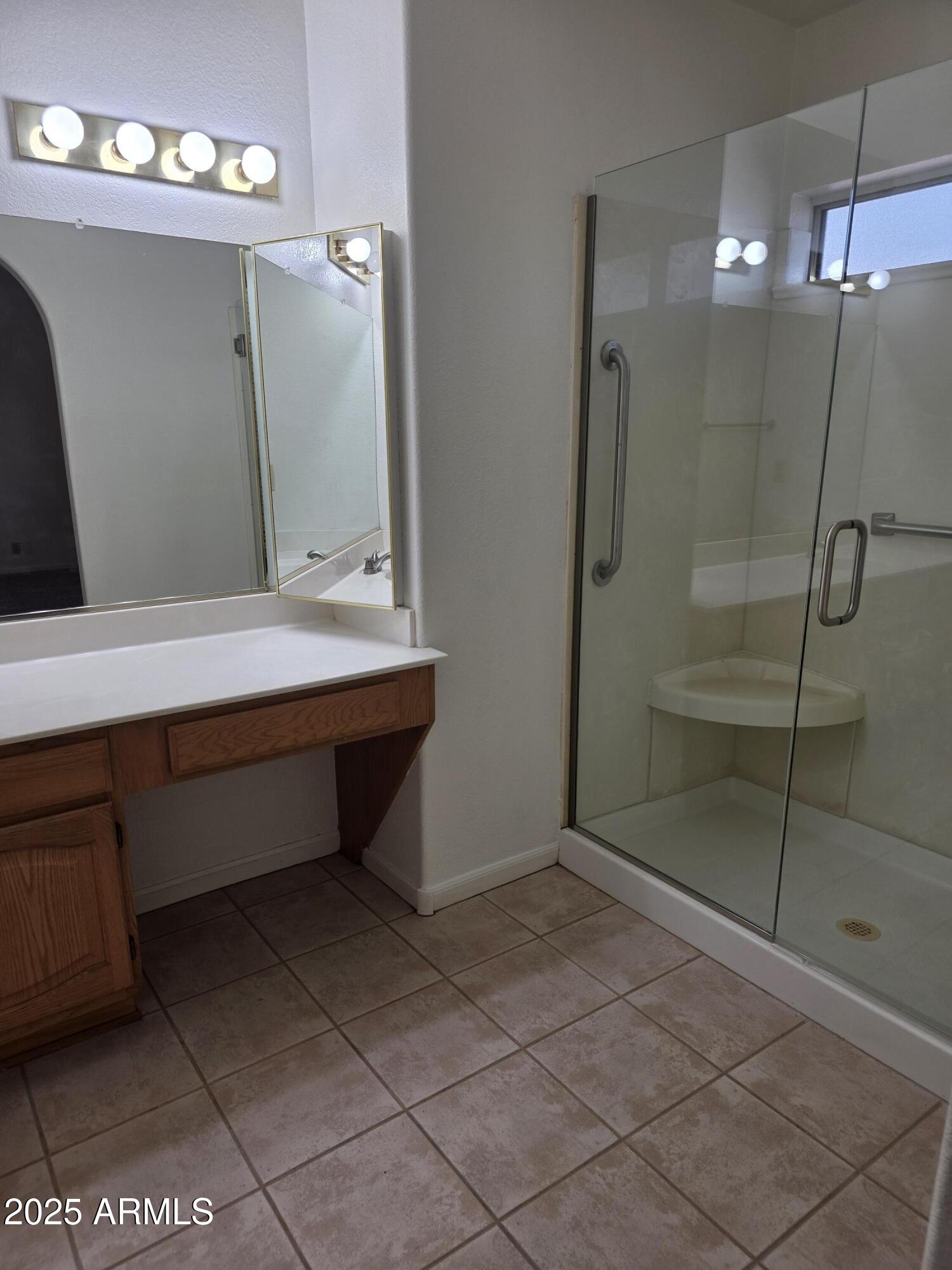 8758 West Bloomfield Road Peoria, AZ 85381 - Photo 16 of 20 a bathroom with a sink mirror and shower