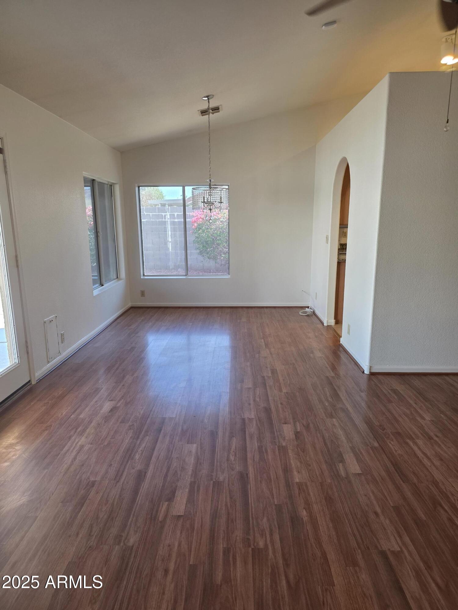 8758 West Bloomfield Road Peoria, AZ 85381 - Photo 6 of 20 an empty room with wooden floor and windows