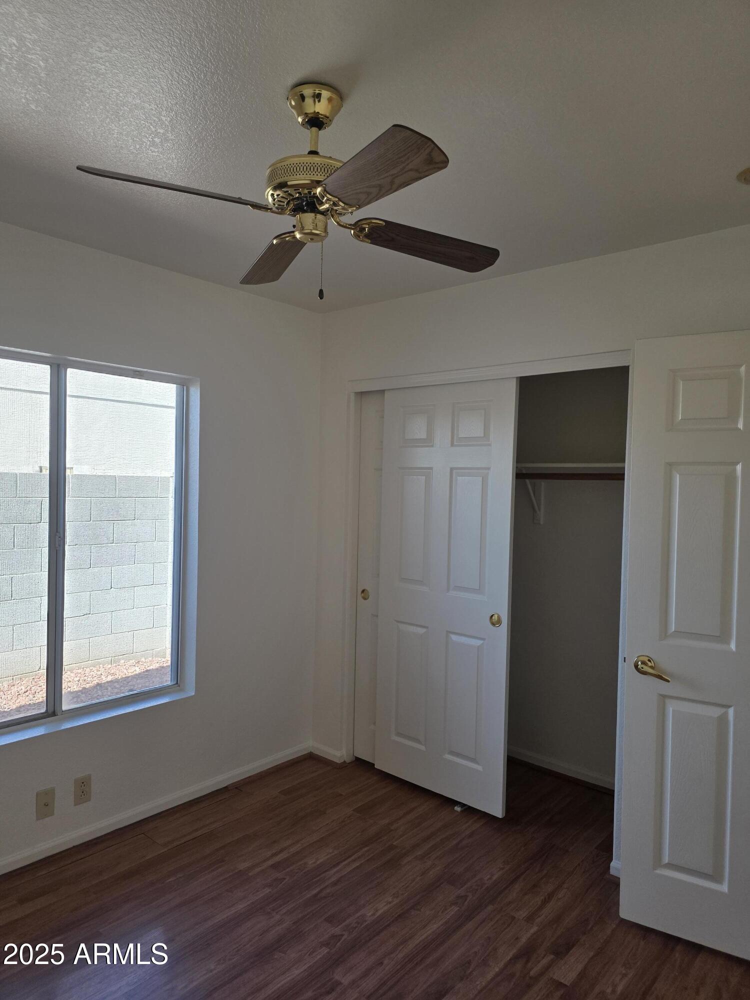 8758 West Bloomfield Road Peoria, AZ 85381 - Photo 10 of 20 a view of an empty room with wooden floor and a window
