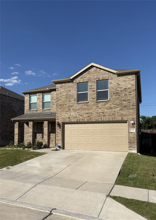 a front view of a house with garage