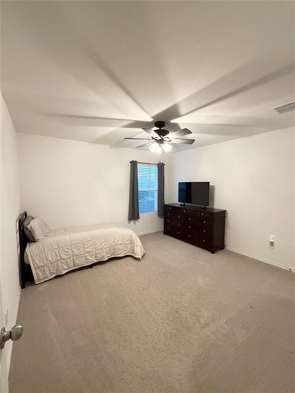 1129 Clear Dusk Lane Forney, TX 75126 - Photo 11 of 13 a spacious bedroom with a bed and a couch