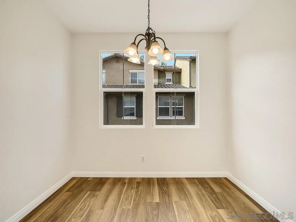 10214 Daybreak Lane, Unit 5 Santee, CA 92071 - Photo 12 of 38 a view of empty room with wooden floor and fan
