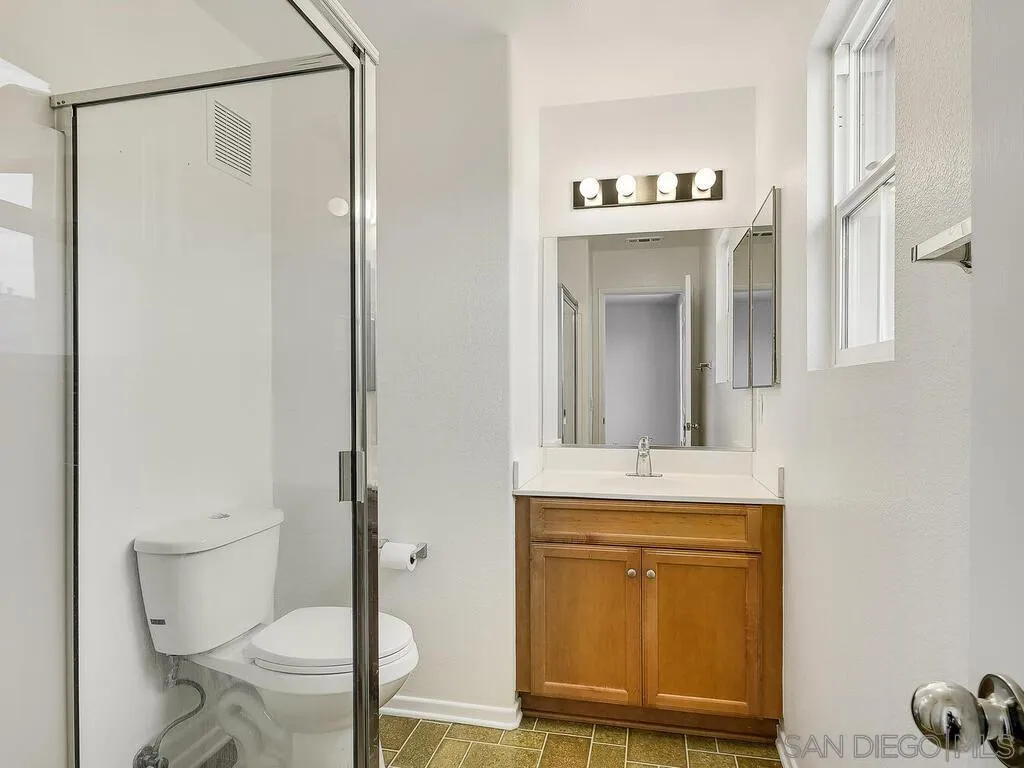 10214 Daybreak Lane, Unit 5 Santee, CA 92071 - Photo 26 of 38 a bathroom with a toilet a sink and mirror