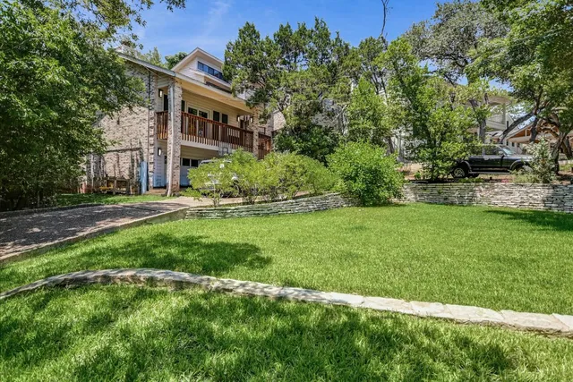 a view of an wooden deck and a garden
