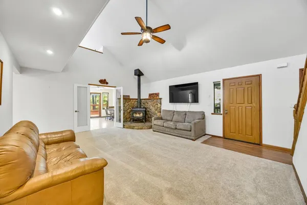 a living room with furniture kitchen view and a window