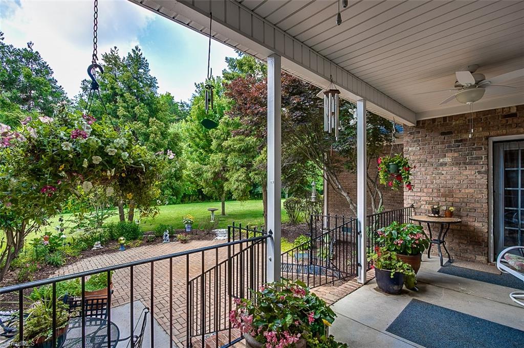 8509 Merriman Farm Road Oak Ridge, NC 27310 - Photo 27 of 30 Covered Porch & Masonry Patio