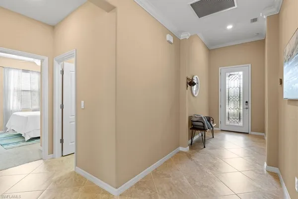 a view of a hallway with bathroom and a view of bathroom