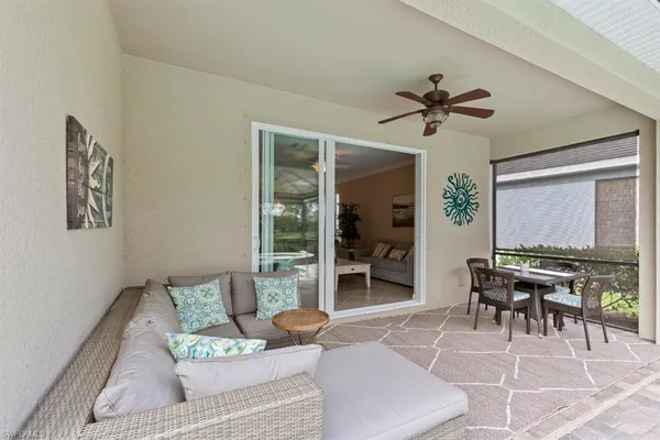 a living room with furniture a large window and a table