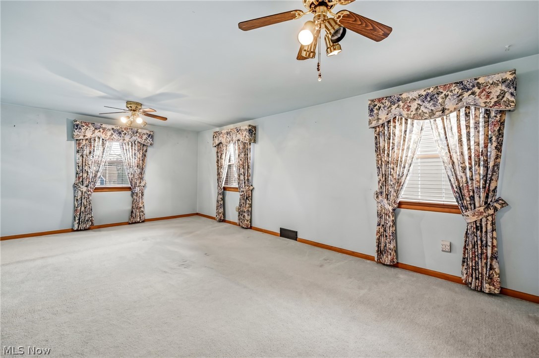 267 Butler Road Northeast Warren, OH 44483 - Photo 28 of 50 Carpeted empty room with ceiling fan and baseboards