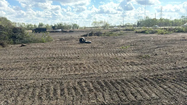a view of a outdoor space with green field and trees