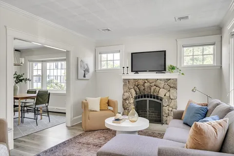 a living room with furniture a fireplace and a flat screen tv