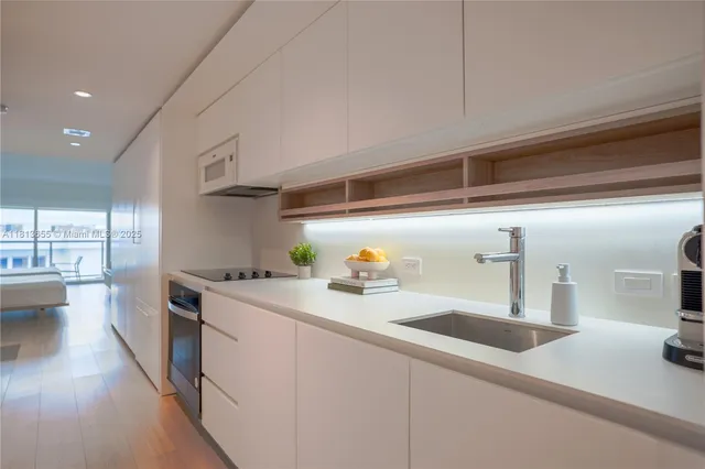 a kitchen with stainless steel appliances a sink and a stove