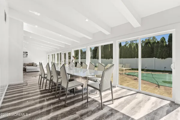 a view of a dining room with furniture wooden floor and garden view
