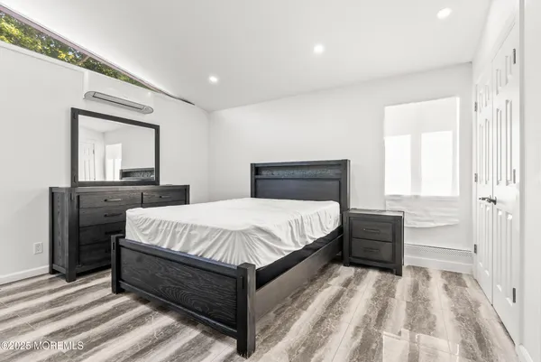 a bedroom with a bed and a dresser