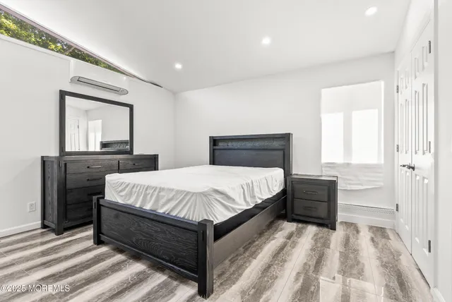 a bedroom with a bed and a dresser