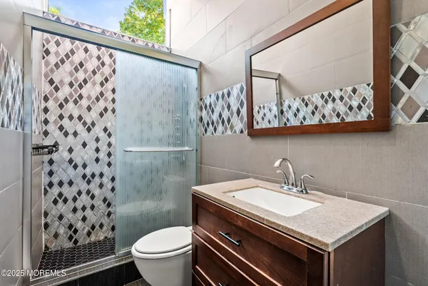 a bathroom with a sink toilet and a mirror
