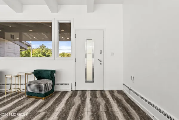 a view of a bedroom with wooden floor