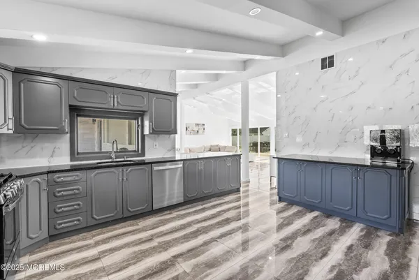 a large bathroom with a sink and a large mirror