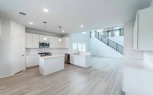 a view of white cabinets and wooden floor