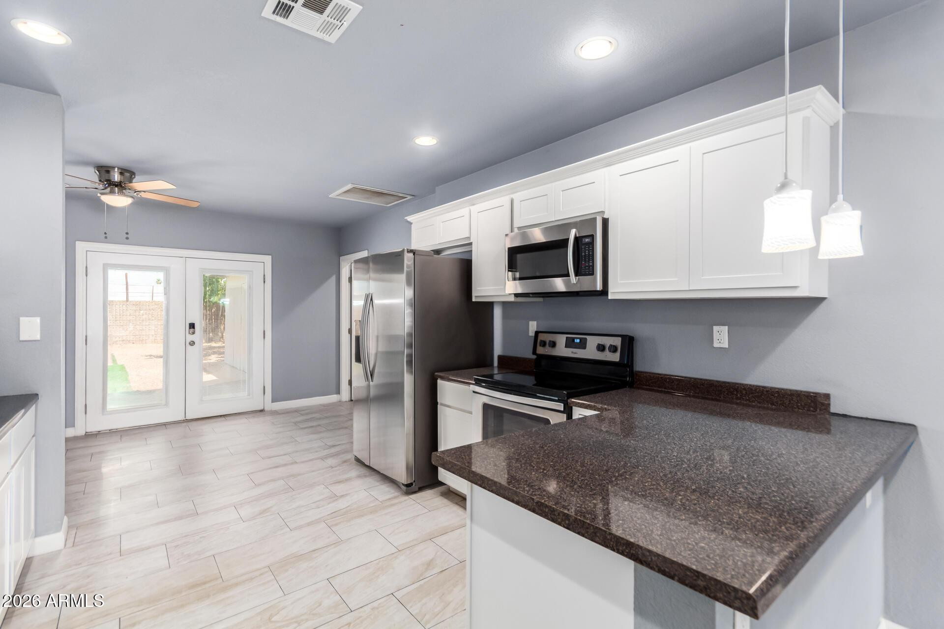 a kitchen with stainless steel appliances granite countertop a sink a microwave counter space and cabinets