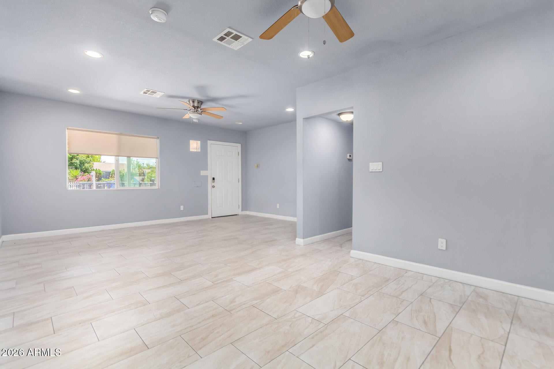 1636 East Whitton Avenue Phoenix, AZ 85016 - Photo 2 of 15 an empty room with windows and entrance