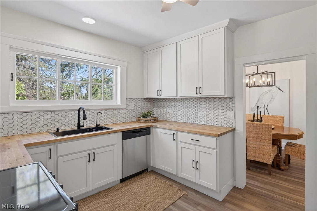 14939 Caves Road Novelty, OH 44072 - Photo 11 of 42 Kitchen with wooden counters, electric range, white cabinets, dishwasher, and light wood-style flooring