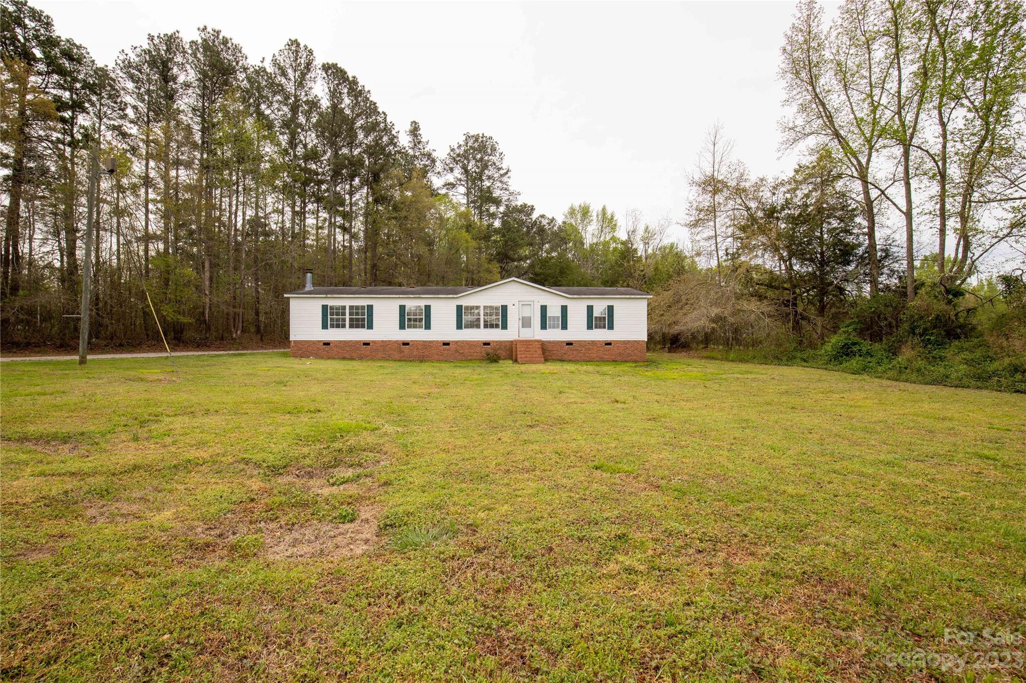 3678 Old Camden Road Heath Springs, SC 29058 - Photo 1 of 34 a view of a lake with a house