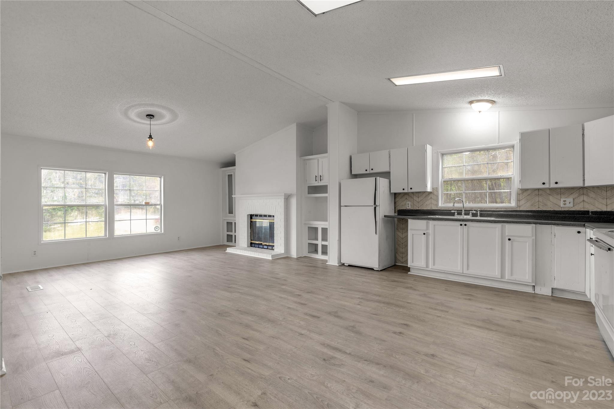 3678 Old Camden Road Heath Springs, SC 29058 - Photo 12 of 34 a view of a kitchen with refrigerator and windows