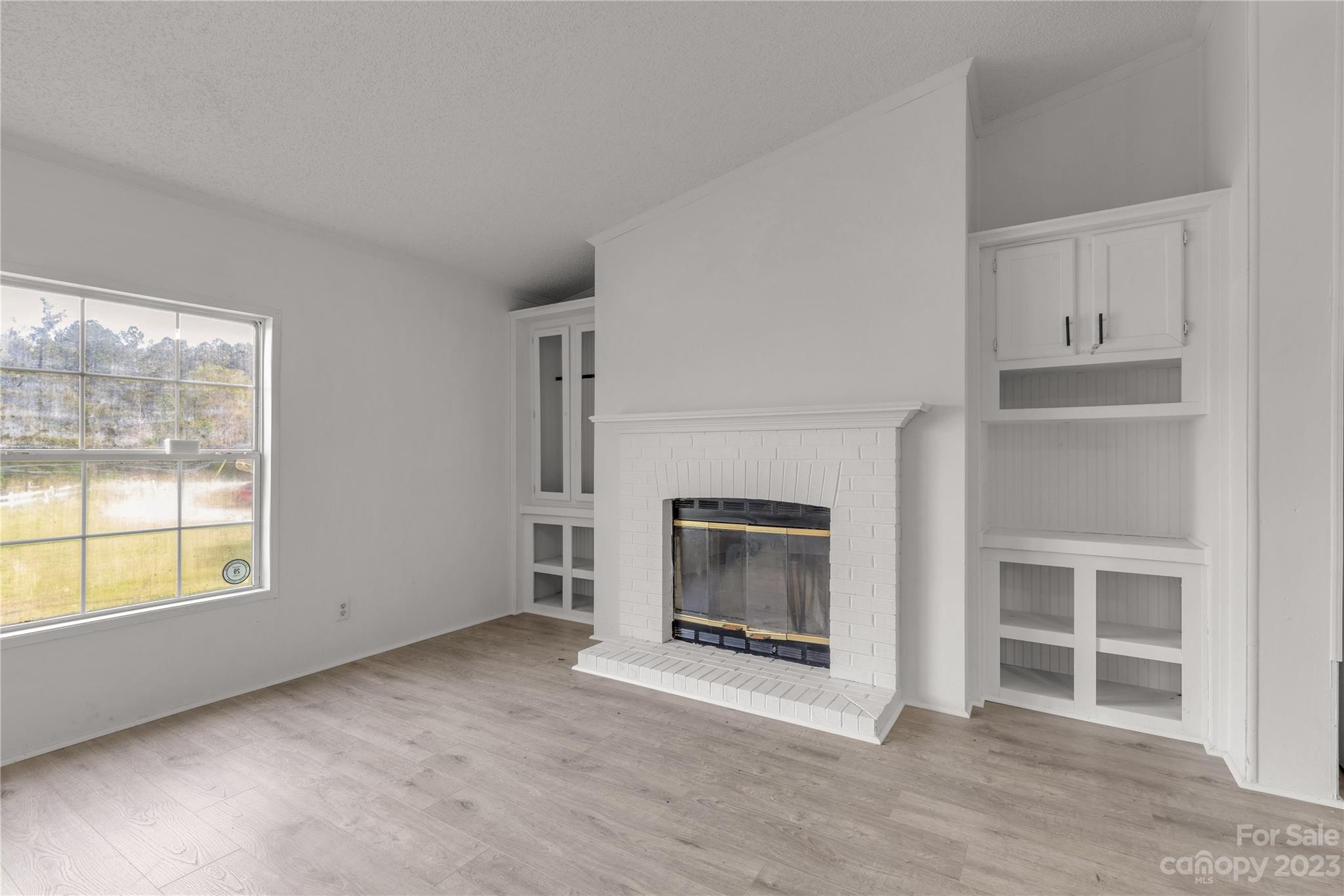 3678 Old Camden Road Heath Springs, SC 29058 - Photo 14 of 34 a view of an empty room with a fireplace and window