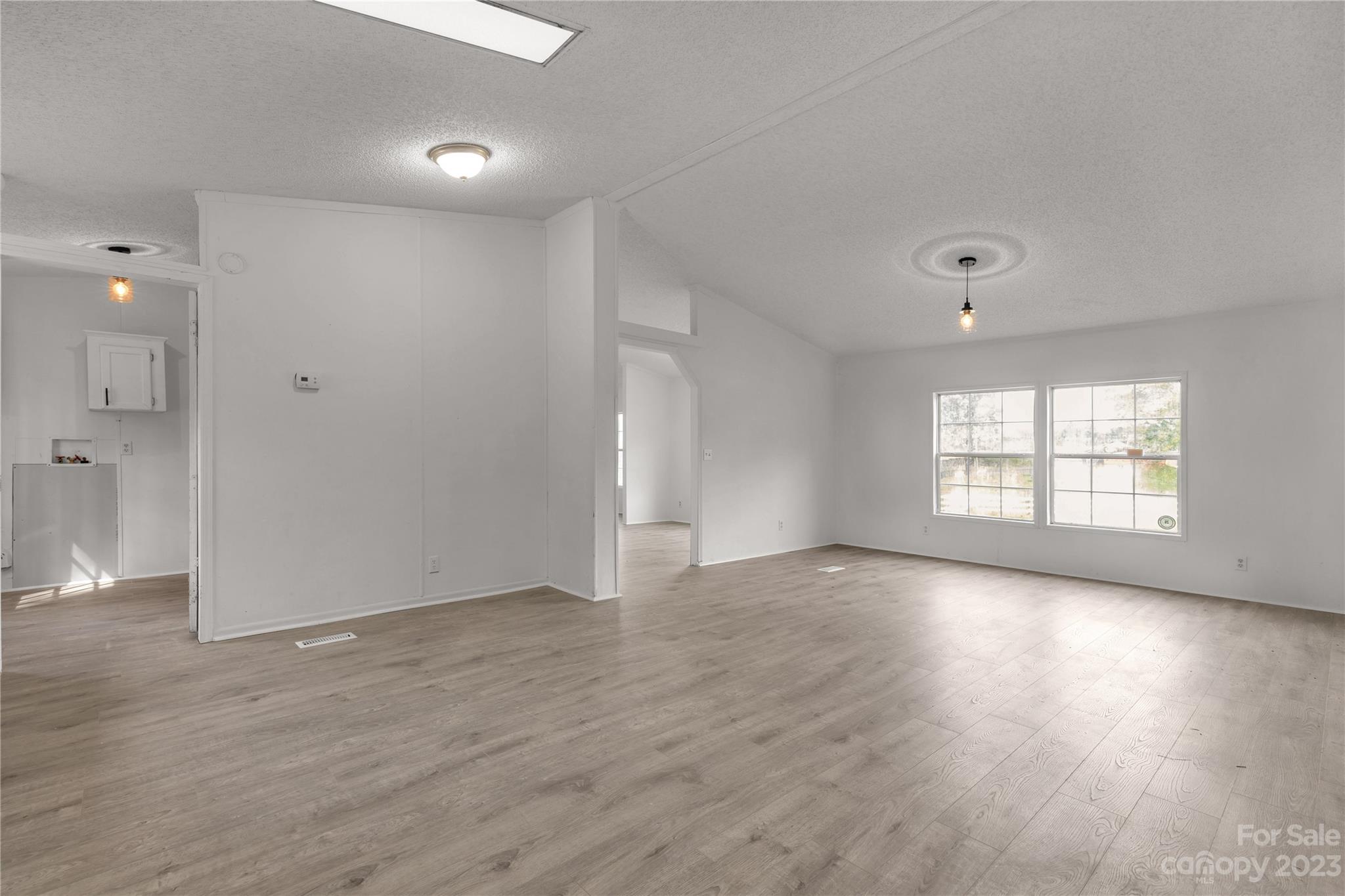 3678 Old Camden Road Heath Springs, SC 29058 - Photo 15 of 34 an empty room with wooden floor and windows