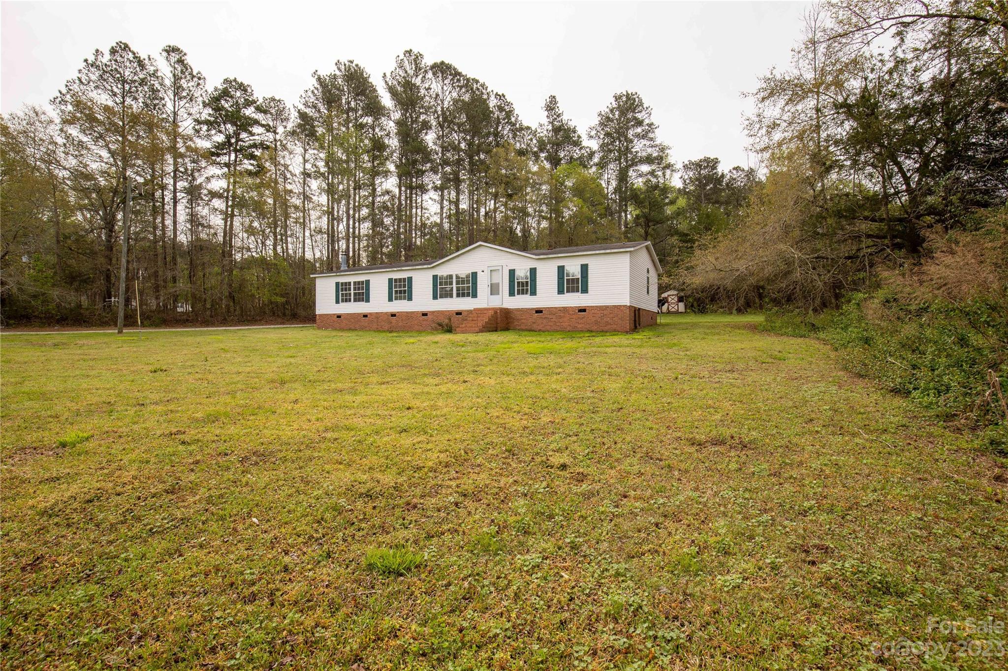3678 Old Camden Road Heath Springs, SC 29058 - Photo 2 of 34 a front view of a house with a yard