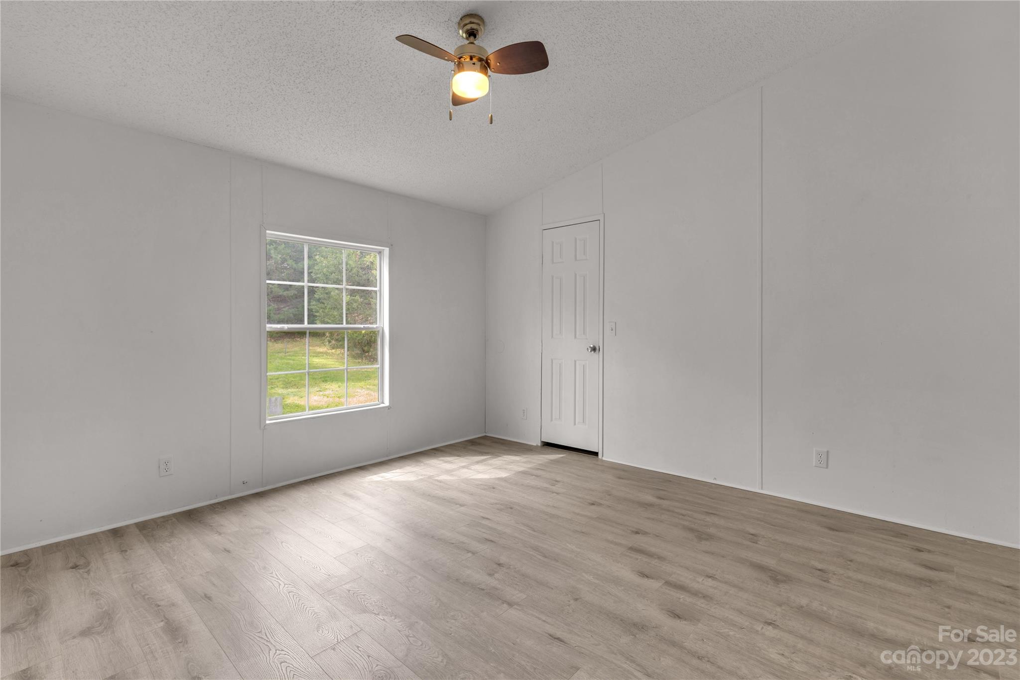3678 Old Camden Road Heath Springs, SC 29058 - Photo 22 of 34 wooden floor in an empty room with a window