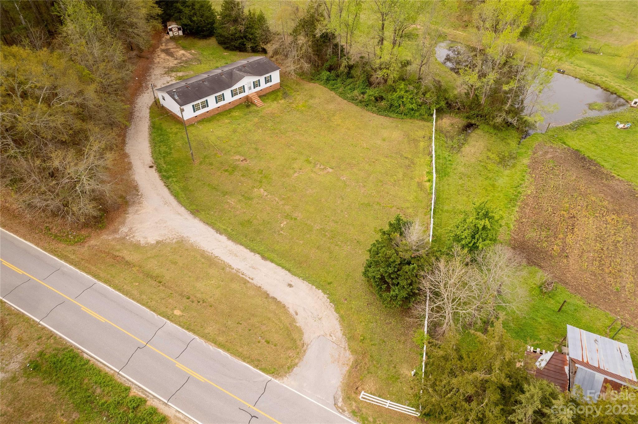 3678 Old Camden Road Heath Springs, SC 29058 - Photo 27 of 34 a view of a swimming pool with a yard