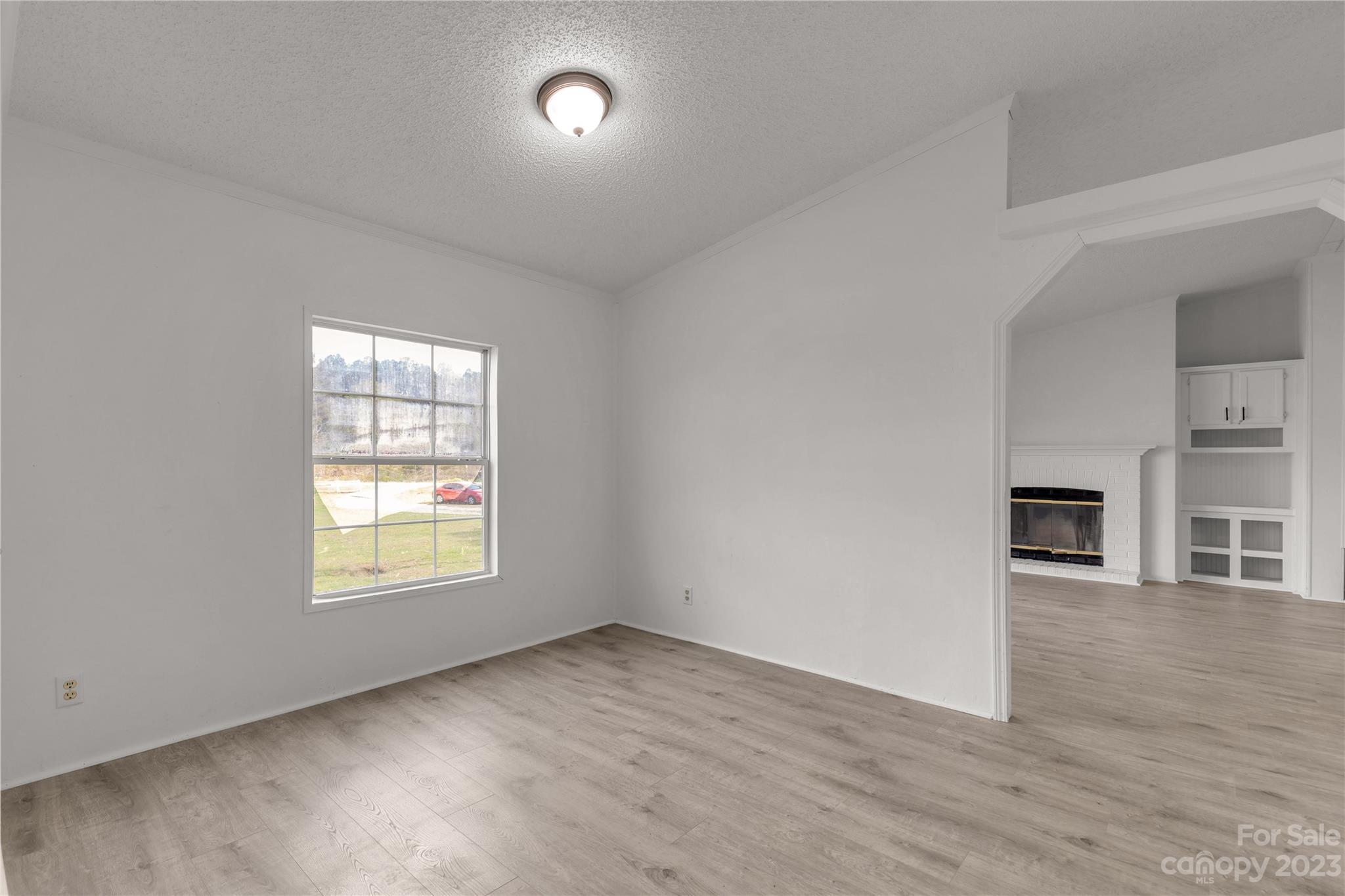 3678 Old Camden Road Heath Springs, SC 29058 - Photo 9 of 34 an empty room with wooden floor and windows