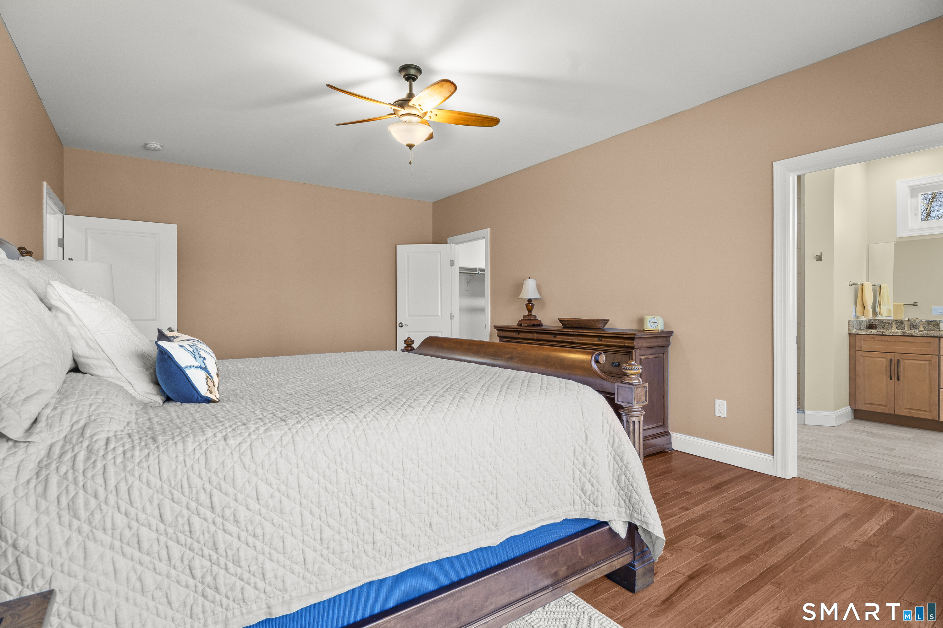 6 Syleo Lane Salem, CT 06420 - Photo 17 of 38 a bedroom with a bed and a chandelier
