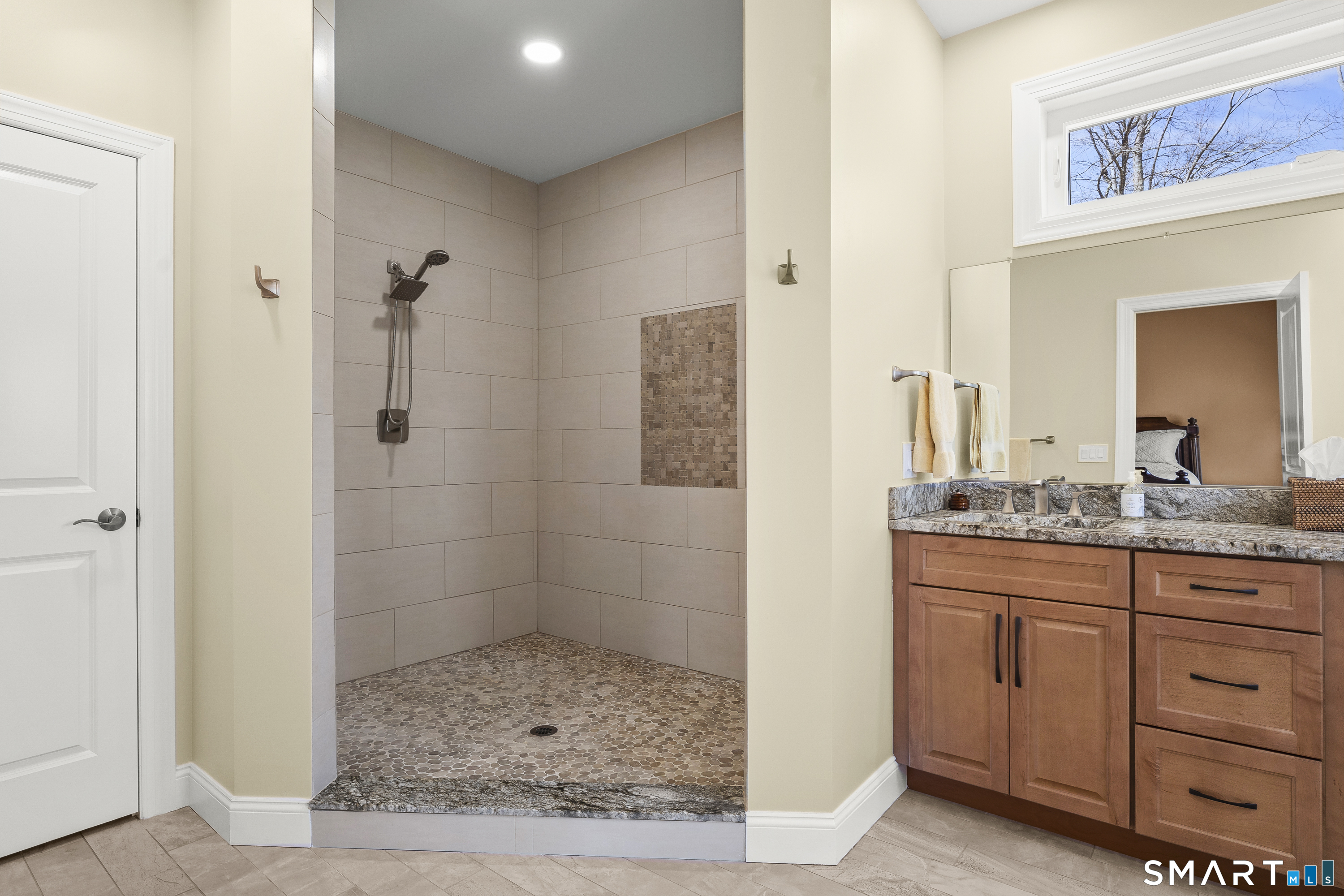 6 Syleo Lane Salem, CT 06420 - Photo 18 of 38 a bathroom with a granite countertop sink a mirror and a shower