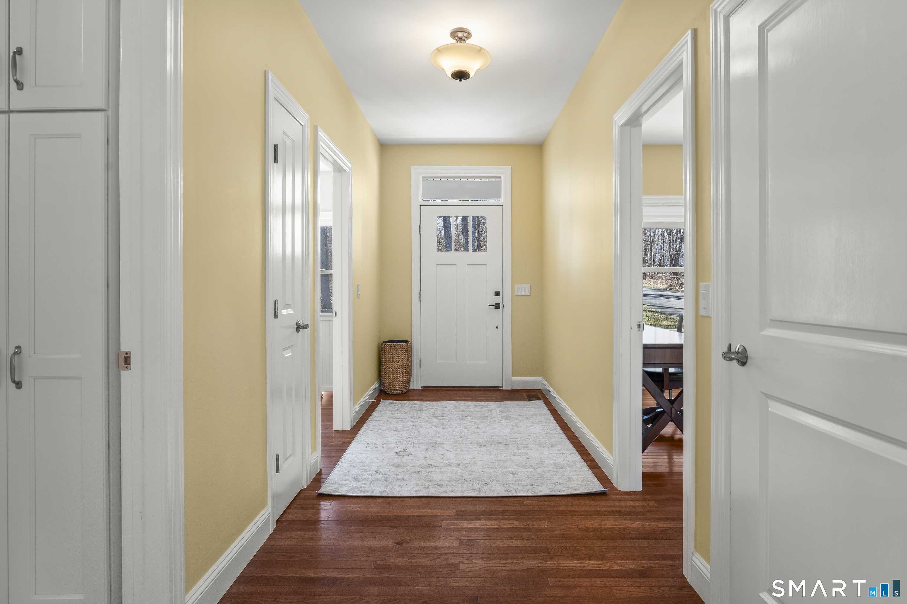 6 Syleo Lane Salem, CT 06420 - Photo 22 of 38 a view of a hallway with wooden floor and a bathroom