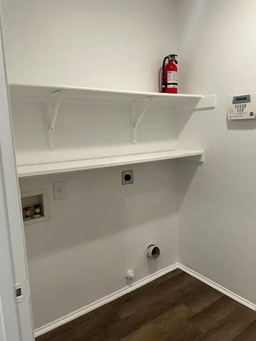 a view of a closet with wooden floor