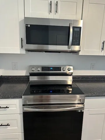 a stove top oven sitting inside of a kitchen