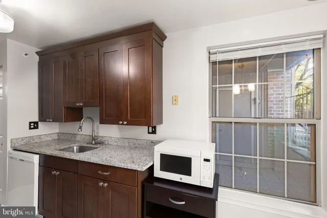 a kitchen with a sink and a mirror
