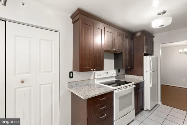 a kitchen with stainless steel appliances granite countertop a sink and a refrigerator
