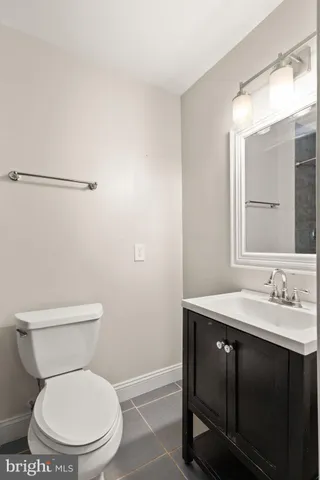 a white toilet sitting next to a bathroom sink