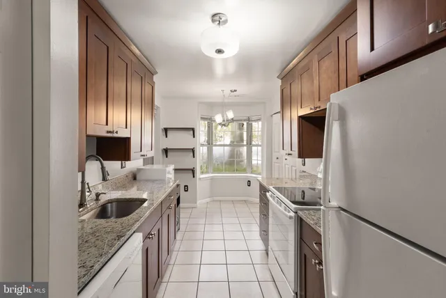 a kitchen with a sink a stove and refrigerator