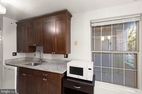 a kitchen with a sink and a mirror