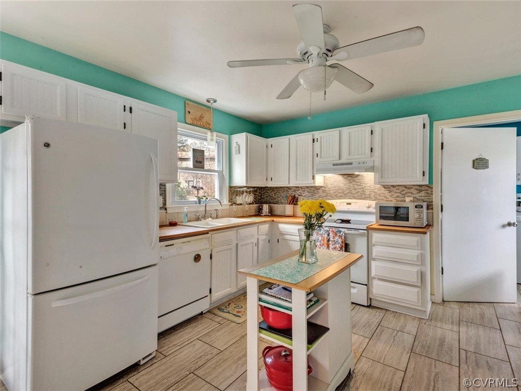2606 Colgrave Road Midlothian, VA 23112 - Photo 5 of 22 a kitchen with stainless steel appliances granite countertop a refrigerator a sink dishwasher a stove and white countertops with wooden floor